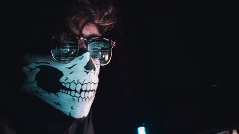 man with skeleton skull mask and glasses