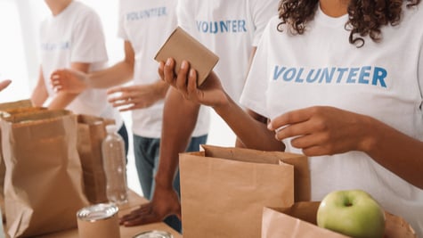 Cropped shot of young volunteers group packing food and drinks for charity