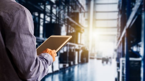 Businessman manager using tablet check and control for workers with Modern Trade warehouse