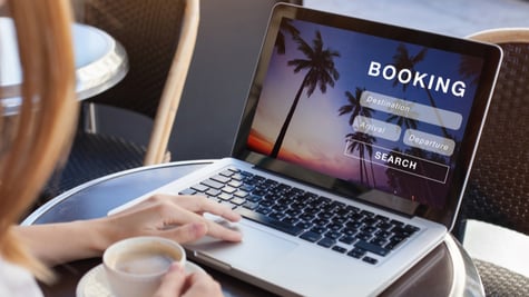Woman booking a holiday on a laptop