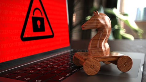Wooden trojan horse on a laptop with red warning screen