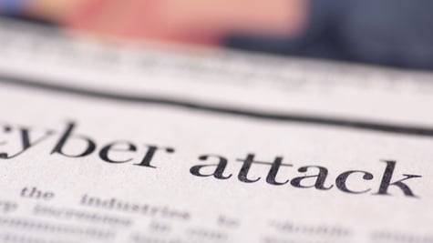 Cyber attack written on newspaper.
