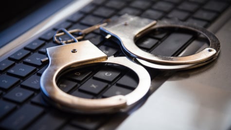 Selective focus on handcuffs on a keyboard