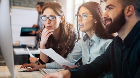 Group of employees looking at PC screen