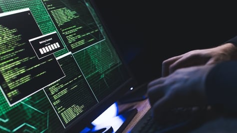 Close-up of Caucasian man hands typing data on a keyboard,seen on a computer monitor