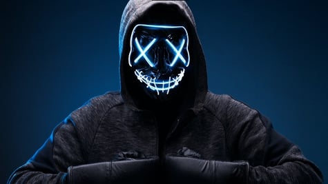 Dangerous hooded hacker in mask and boxing gloves