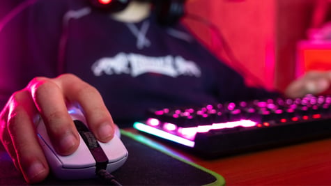 Professional guy typing on his keyboard and playing some game