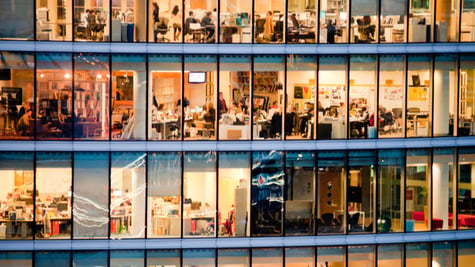 People work in an office building at night