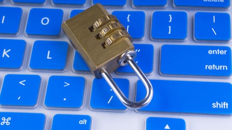 Closeup of computer security concept with a closed padlock on the keyboard