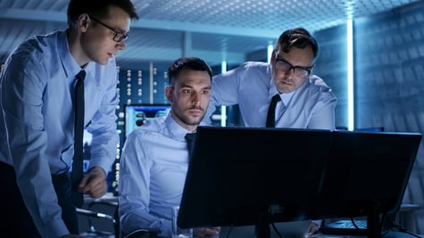 Three Operations Engineers Solving Problem in a Monitoring Room