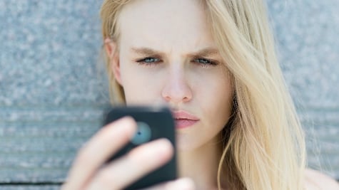blond woman holding a smartphone