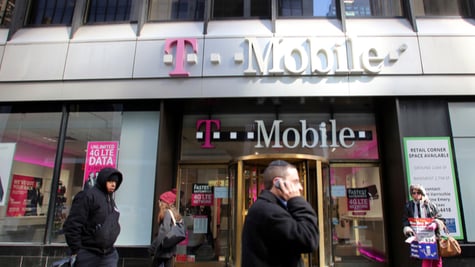 passengers walking by T Mobile shop