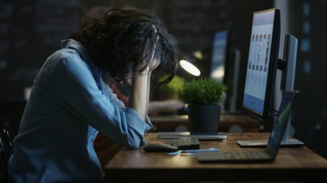 Tired woman sitting in front of PC