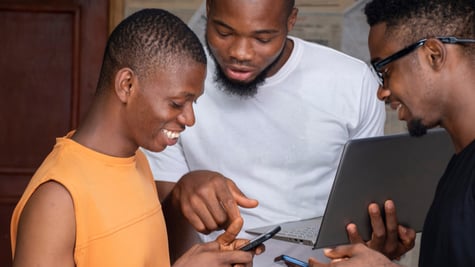 Three young african people using their mobile phones and laptops