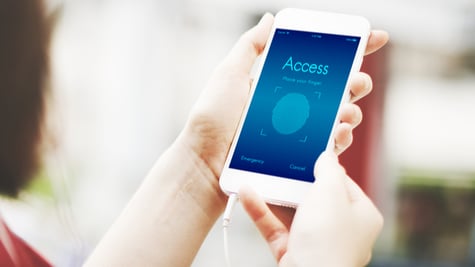 Woman holding phone, digital ID access on screen