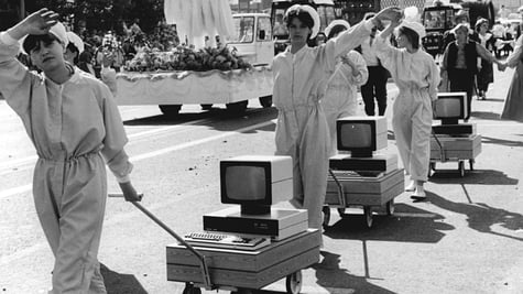 Women pulling old computers - black white picture