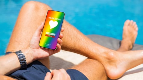 Man using gay and LGBT dating app on his mobile phone