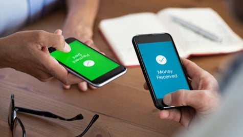 Closeup hands holding mobile phone with application for send and receive money.