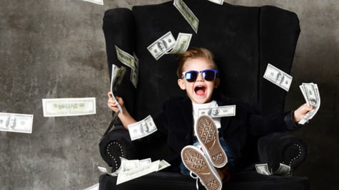 Rich kid throwing money