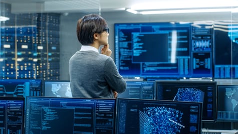 Technical operator monitoring activities on multiple displays