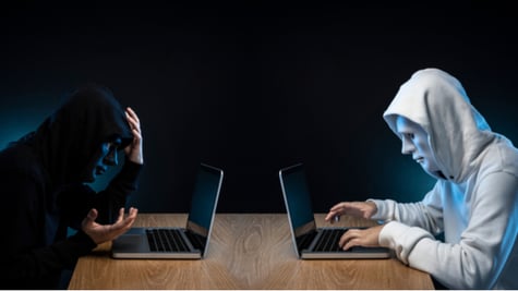 Hackers sitting with masks to each other