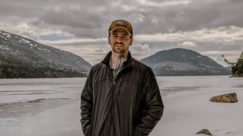 Defense industry cybersecurity analyst Chris Haller in casual pose against snowy tundra backdrop