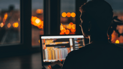 hacker in from of a computer in a dark room