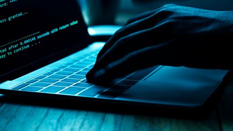 Squirrelwaffle malware concept, hands and a keyboard