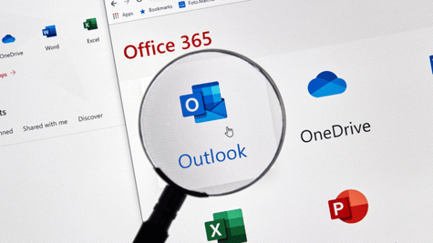 Magnifying glass zooming in on Microsoft graphic on computer screen