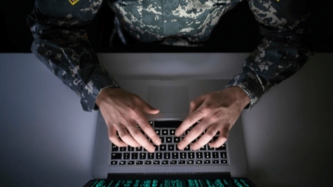 Aerial shot of soldier sitting at computer terminal