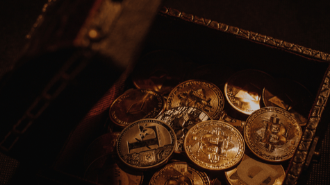 Chest in shadowy light with Bitcoins spilling from it