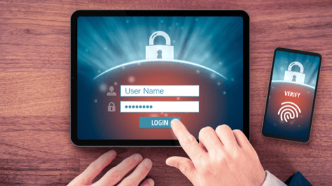 Laptop, mobile phone and user in desktop demonstration of multifactor authentication