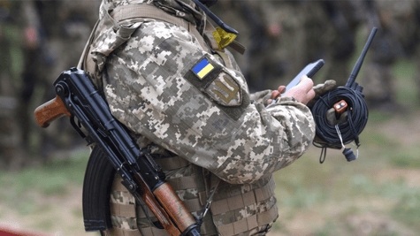 Soldier with a smart phone and a gun