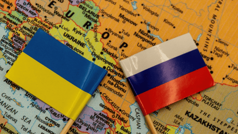 Ukrainian and Russian flags seen on a map