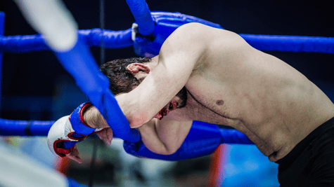 Figurative image of boxer on the ropes, as DeFi protocols get pounded by cybercriminals