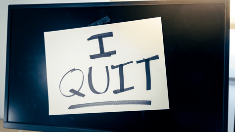 Computer screen with I Quit post-it note attached