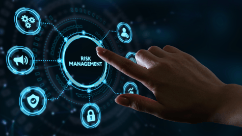 Female hand touching interactive digital console that says risk management