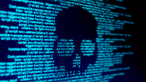 Computer code on a screen with a skull representing a computer virus
