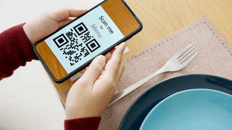 phone in the hands with QR code on the screen