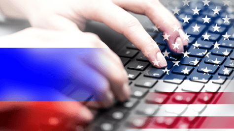 russian and the US flags in front of a keyboard