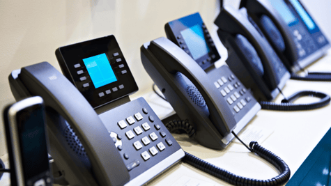 Row of digital landline handsets, such as are used in call centers