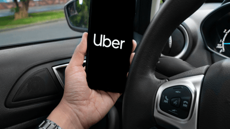 Driver holding phone in stationary vehicle.