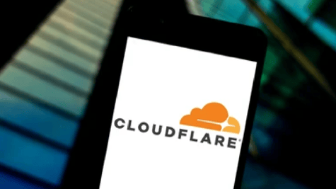 Mobile phone with cloudflare logo building looming