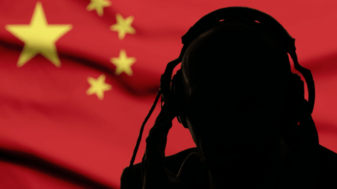 Silhouette of man on headphones against Chinese flag background