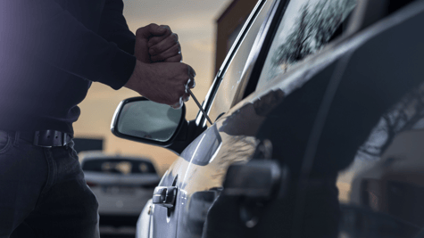Car thief jemmying door of car