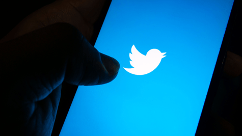 Generic pic of hand holding cellphone with Twitter logo