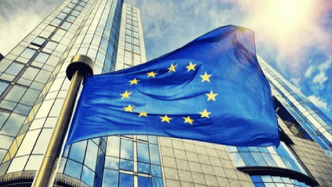 Looming building with EU flag in foreground