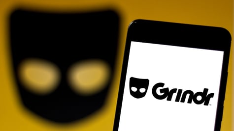 The logo of grindr app on a smartphone screen.