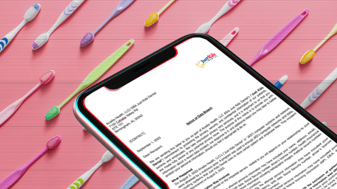 Toothbrushes in background with letter from JKD
