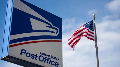 US Postal Service sign and US flag